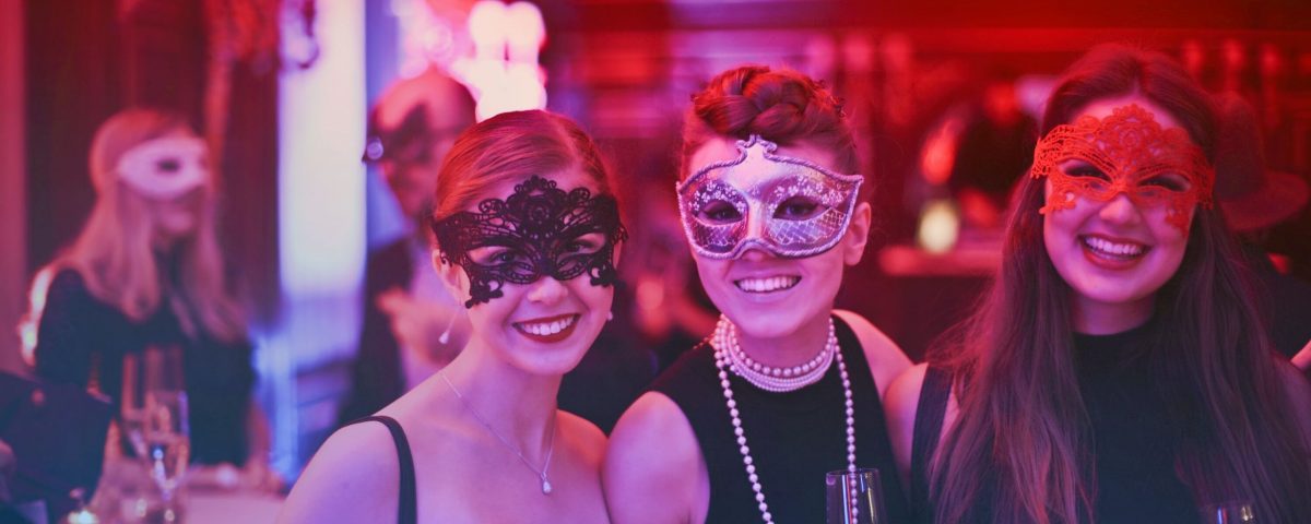 women in masquerade masks, event venue