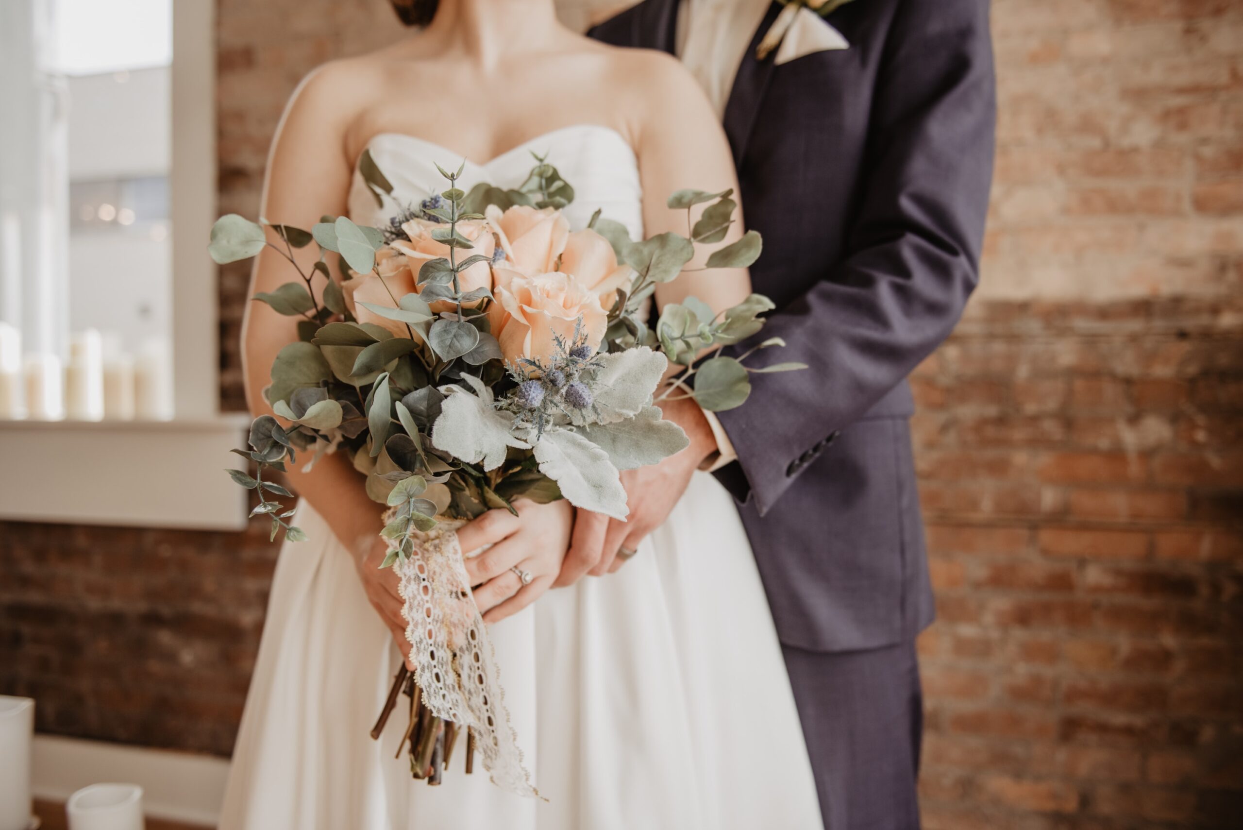 bride and groom holding bouquet on wedding day