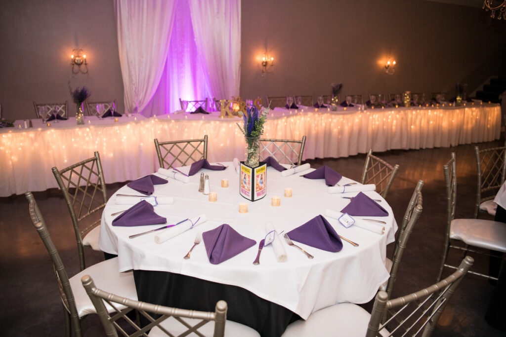 Table set with purple and white cloths, an elegant dining setup