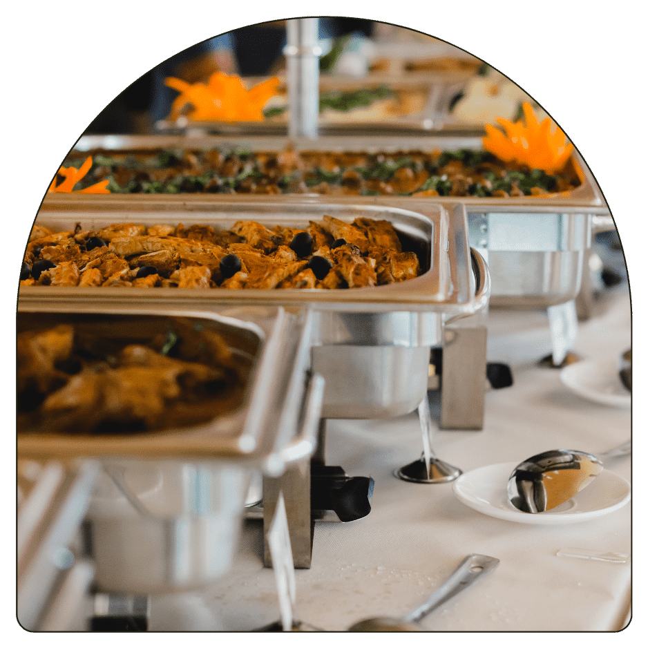 A buffet table elegantly arranged with a variety of food items and utensils for serving.